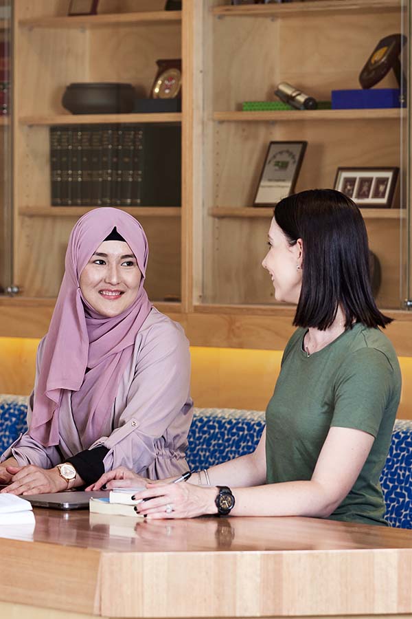 Graduate Certificate in Counselling Online student wearing Hijab chatting with her friend