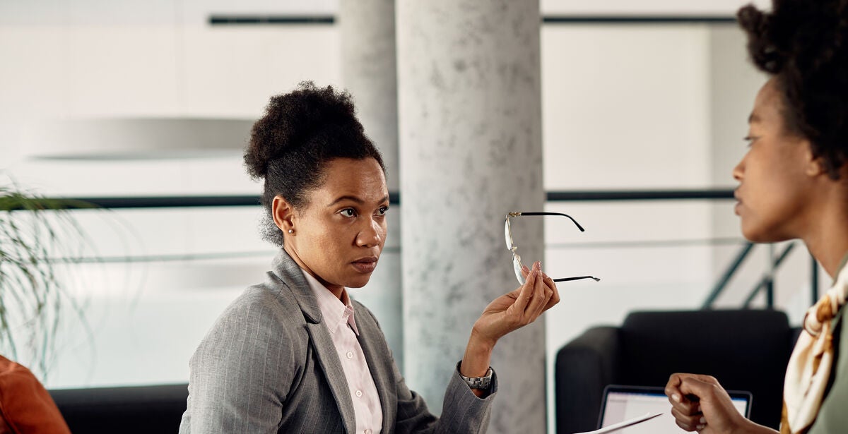 Young women sitting in an office talking about how to become a lawyer.