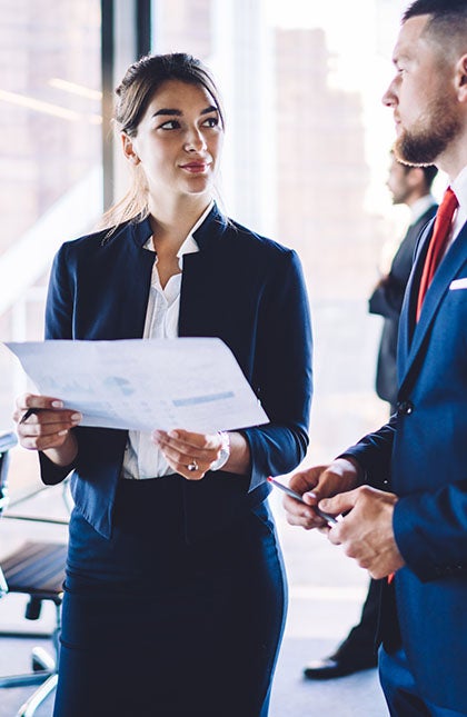 One UC online student reading a book and smiling