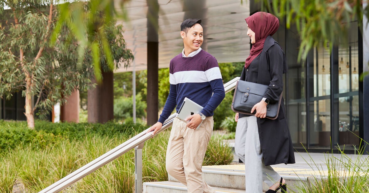 A woman and a man climbing down the steps talking about ways of developing public policy
