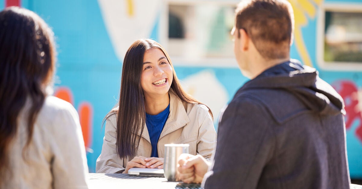 Group of three adults sitting around discussing the skills and qualities of a counsellor