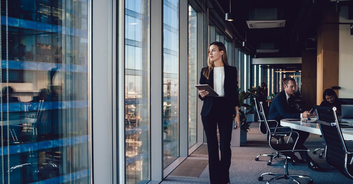 A woman in corporate attire thinking about the appropriate types of policy analysis