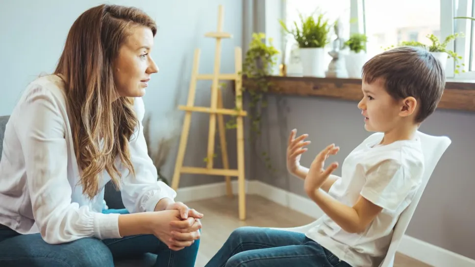 A school counsellor meets attentively with a student in a calm and welcoming school environment.