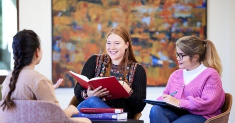 A group of three female students talking about active listening skills in counselling